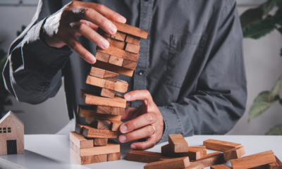 a man playing with a stack of wooden blocks