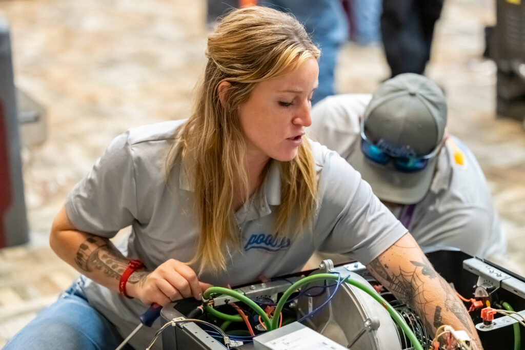 a woman working on a pool heater